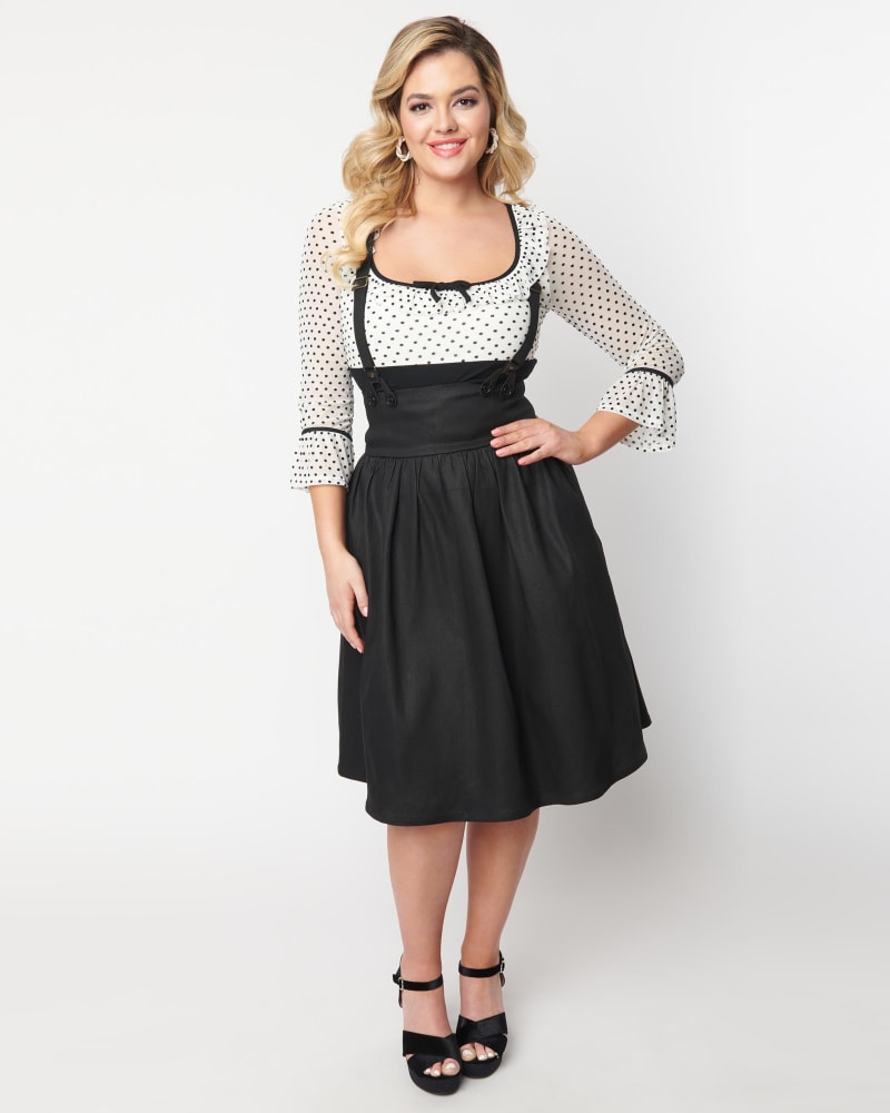 Front of a model wearing a size 4X/22-24 Unique Vintage Dark Denim Black High Waist Suspender Swing Skirt in Dark Denim by Unique Vintage. | dia_product_style_image_id:300995